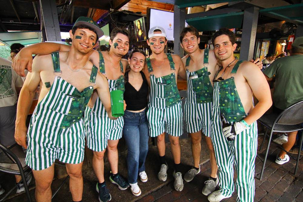 TGG attendees in matching overalls at the event