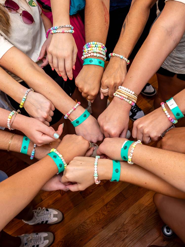 TGG attendees showing wristbands